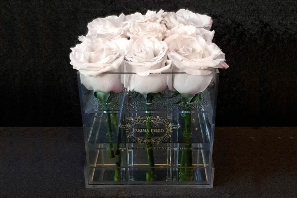 9 fresh white roses in Small Acrylic Clear Square Box